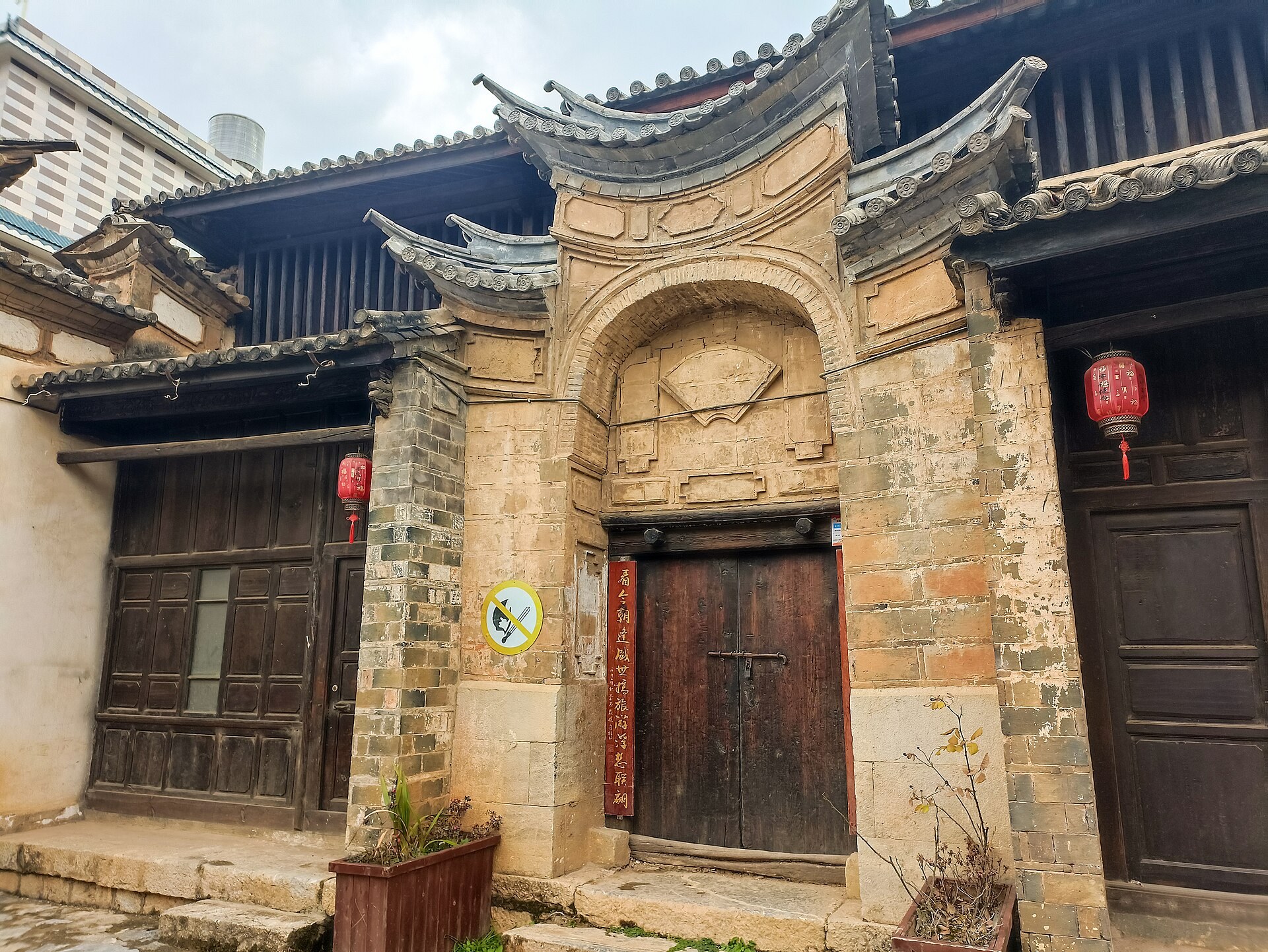 A carved stone doorway in a historic Yunnan courtyard house.