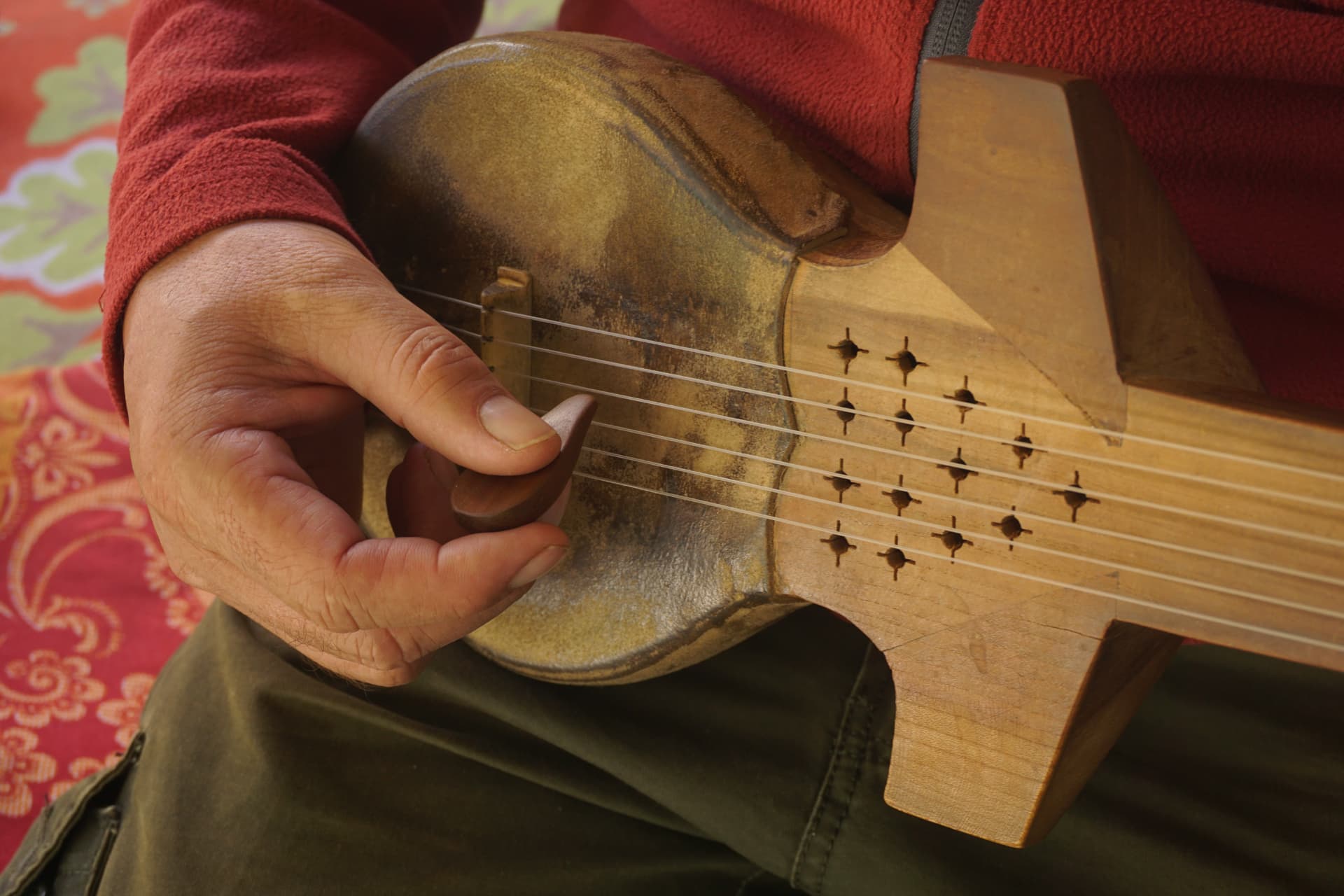 A Pamiri rubab played with a wooden plectrum.