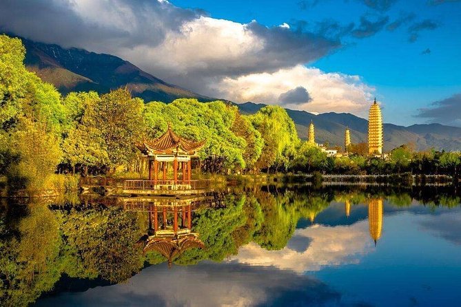 The Three Pagodas of Dali reflected in a still pond below the Cangshan mountains