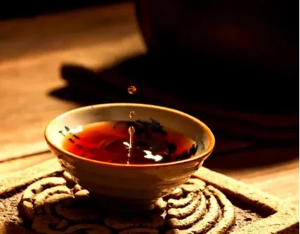 Tea being poured into a ceramic cup during a traditional Chinese tea ceremony